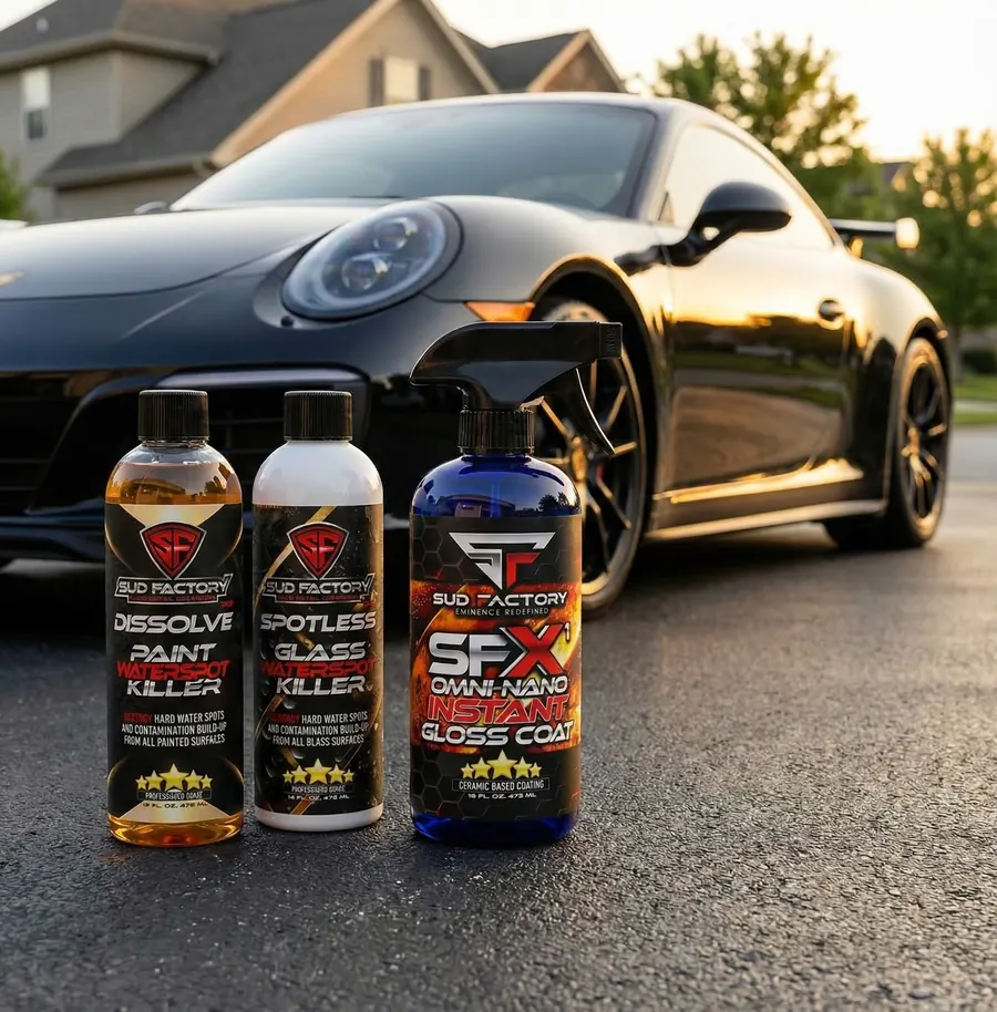 Ultimate Bundle bottles in front of a black sports car