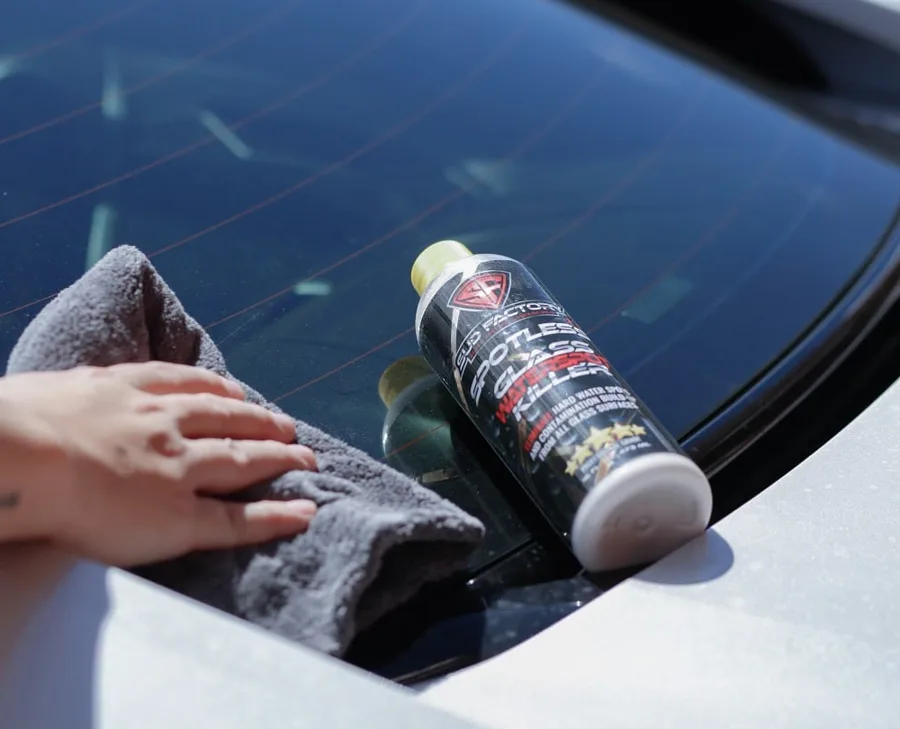 Wiping a windshield clear with a microfiber towel