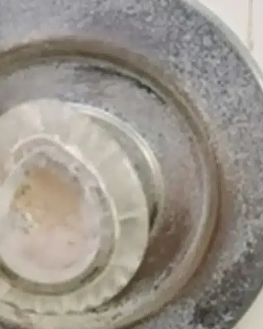 Bathroom sink drain before: crusted with mineral scale