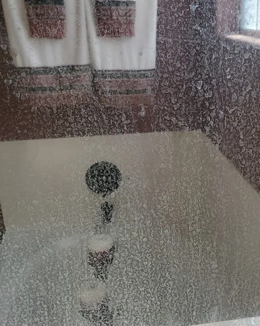 Shower glass before: clouded with hard water spots