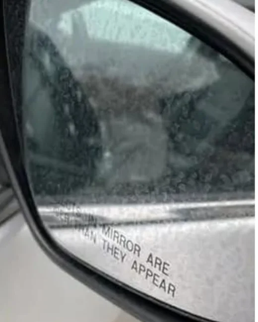 Side mirror before: glass covered in hard water spots