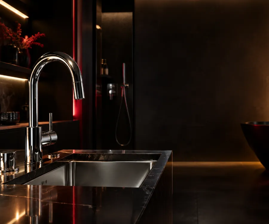 Shiny chrome kitchen faucet over a clean sink
