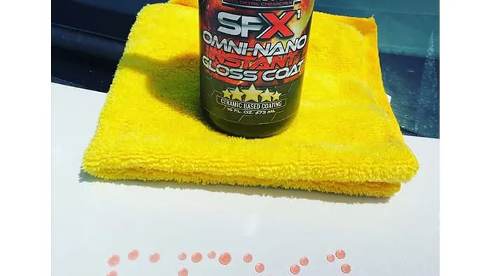 SFX1 bottle and microfiber towel on a coated panel