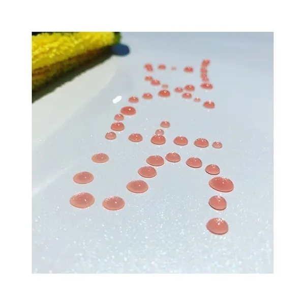 Water beads on a white panel coated with SFX1