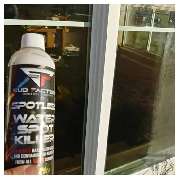 Customer holding Spotless X2 in front of a cleaned window